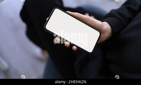 Mock up of a smartphone blank screen on a woman's hand. Mockup screen for display your graphic Stock Photo