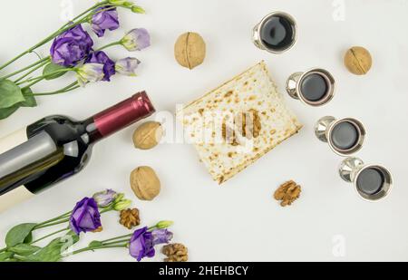 the concept of the Passover holiday. Pesah . top view of matzah, silver glasses with red wine, a bottle of wine, walnuts Stock Photo