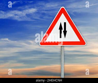 Triangle road sign two way traffic on rod Stock Photo