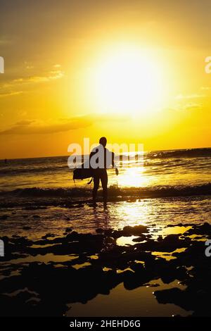 Silhouette of surfer at red sunset. Kuta beach. Bali Stock Photo - Alamy