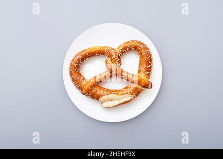 Pretzel as Oktoberfest symbol  on white ceramic plate, top view Stock Photo