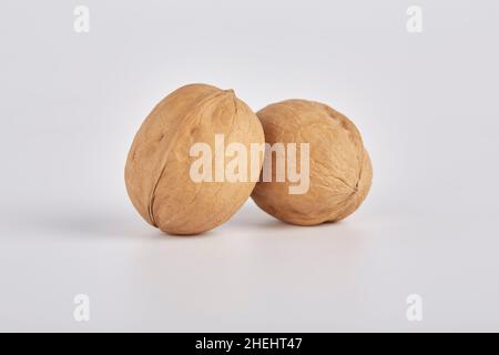 Two walnuts on a light background close-up Stock Photo