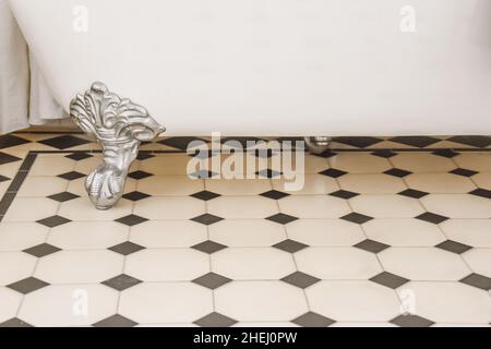 Jacuzzi bottom on tiled black and white checkerboard marble floor Stock Photo