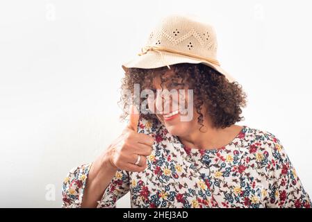 Close-up portrait of smiling Brazilian mature woman, wearing cap Stock Photo