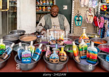 A Sand Artist and His Colourful Sand Bottles, Aqaba, Aqaba Governorate, Jordan. Stock Photo