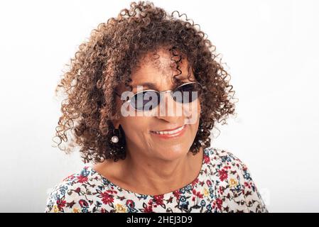 Close-up portrait of smiling Brazilian mature wearing vintage sunglass Stock Photo