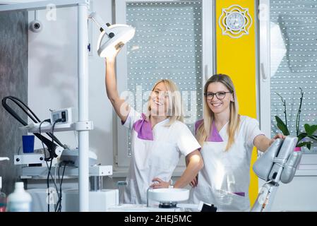 Two female coworkers smiling during their shift Stock Photo