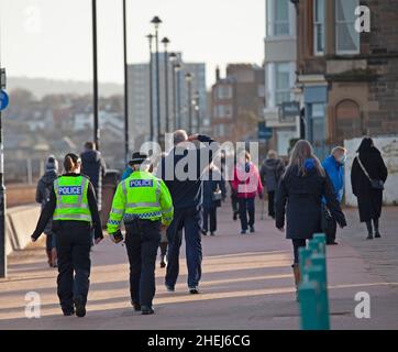 Portobello, Edinburgh, Scotland, UK. 11th Jan, 2022. Police presence on promenade the female officers had been asking members of the public for any detailed information regarding missing Alathea (Alice) Byrne if they were at the beach on the morning of 1st January 2022 when the young woman was last seen, taking thorough notes from anyone who was. Officers are also conducting house to house enquiries in the Portobello area. Credit: Archwhite/Alamy Live News Stock Photo