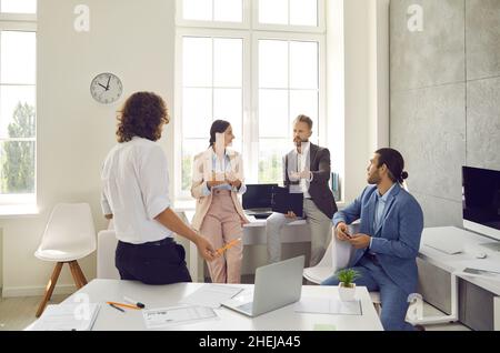 Group of employees talking about a business project they are working on together Stock Photo