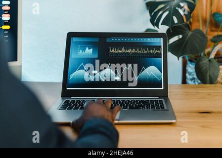 Crop black businessman typing on laptop Stock Photo