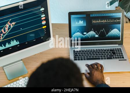 Crop black businessman typing on laptop Stock Photo