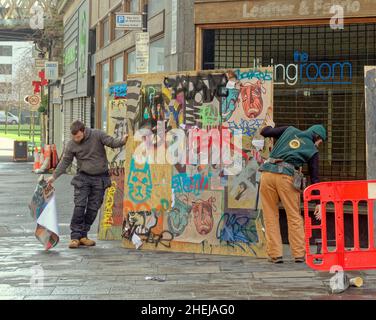 Glasgow, Scotland, UK. 11th Jan, 2022. New Batgirl film set latest as the road closures are in place with the shop fronts being built with art deco building and mercat cross with graffiti being used to communicate the dystopia. Credit: gerard ferry/Alamy Live News Stock Photo