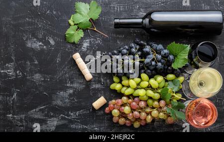 Assortment different types of wine and grade varieties. Tasting White rose red wine in glasses near white pink and black grapes, red wine bottle on Stock Photo