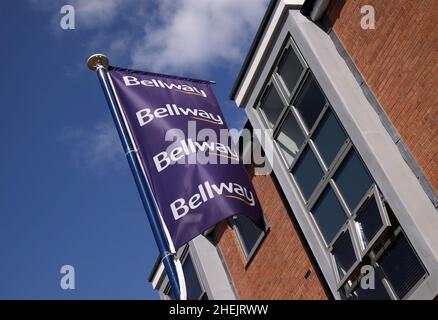 Bellway homes flag sign outside newly built homes houses property, blue sky. Stock Photo