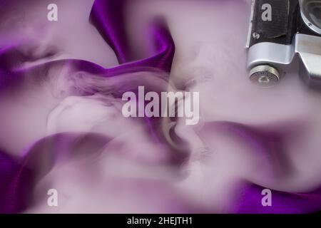 smoke or mist over curved purple satin fabric Stock Photo