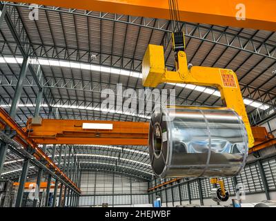 lifting master steel coils for move inside warehouse Stock Photo