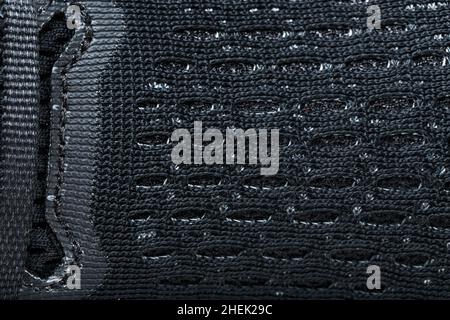 Mesh of black sports sneakers for training close-up in full screen Stock Photo