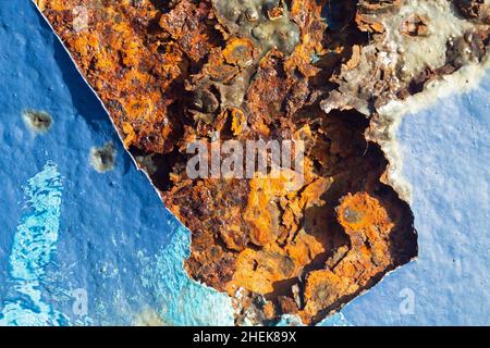 Close up shot of a very rusty blue painted iron surface. Stock Photo