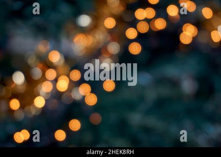 Blurred Christmas lights in tree. Abstract bokeh holiday background. Stock Photo
