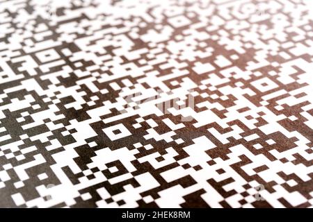 Close-up of QR code printed on paper. Abstract QR background with light leak. Stock Photo