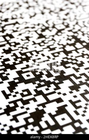 Close-up of QR code printed on paper. Vertical abstract QR background in black and white. Stock Photo