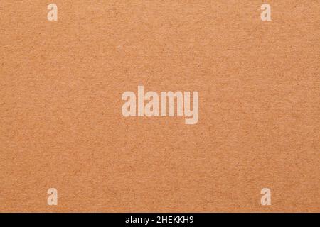 Flat Brown Cardboard Smooth Textured Background Close Up. Stock Photo