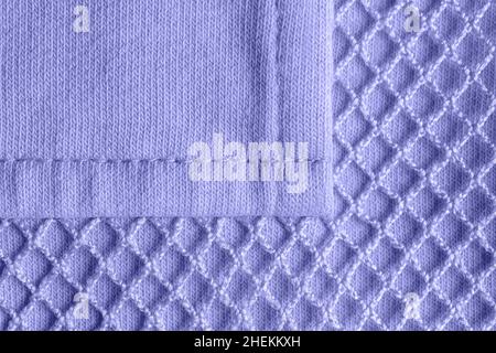 Patch pocket on blue violet mesh cotton jersey macro. Texture of knitted fabric for modern sportswear. Casual clothing in trendy color 2022 very peri. Stock Photo