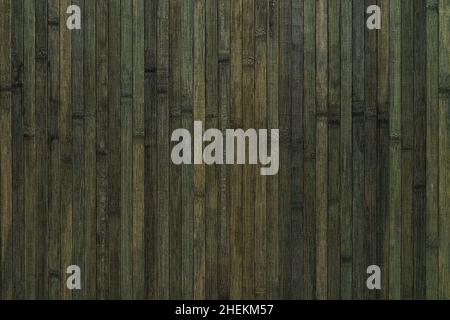 Vertical lacquered bamboo wood planks with striped pattern background. Surface of greenish black colored bamboo board texture. Interior design element Stock Photo