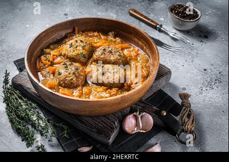 Cutlets or Fish balls with tuna in tomato sauce. Gray background. Top view Stock Photo