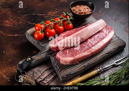 Raw Picanha meat steak, traditional Brazilian beef cut with thyme. Wooden background. Top view Stock Photo