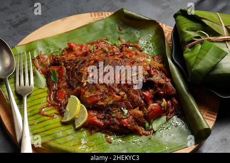 Meen Pollichathu or fish pollichathu, tasty kerala dish, fish with masala cooked in banana leaf. Stock Photo