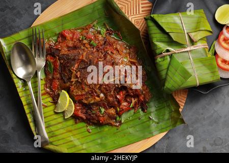 Meen Pollichathu or fish pollichathu, tasty kerala dish, fish with masala cooked in banana leaf. Stock Photo