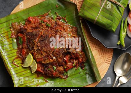 Meen Pollichathu or fish pollichathu, tasty kerala dish, fish with masala cooked in banana leaf. Stock Photo