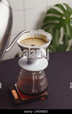 Barista pours ground coffee to aeropress Stock Photo by bublikhaus