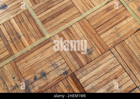Old used parquet with square pattern made of rectangular wooden planks, top view. Background photo texture Stock Photo