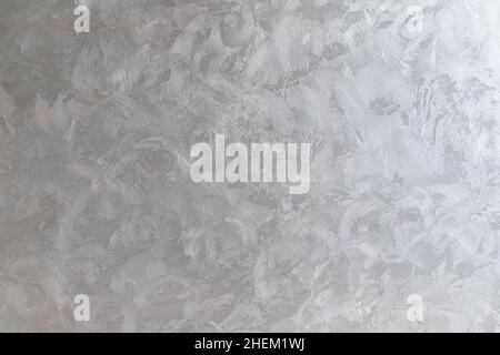 Background texture of a wall covered with decorative gray Venetian plaster, frontal view Stock Photo