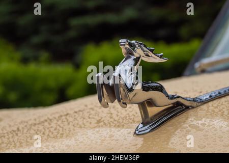 Figurine of deer on the hood of GAZ M21 Volga at Classic Soviet Car Exhibition Stock Photo