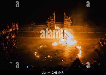 Bali - Indonesia - 10.21.2015: Kecak dancers performing the Fire Dance in the Pura Luhur Uluwatu amphitheater, Uluwatu Temple a Balinese Hindu sea tem Stock Photo