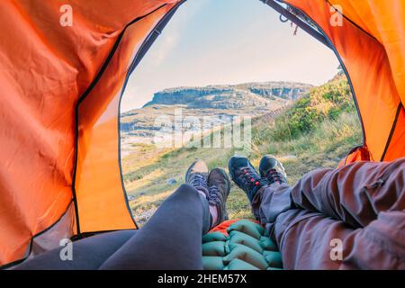 View from tourist tent inside on the mountain landscape. couple at the mountains Stock Photo