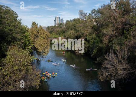 Austin Texas USA, October 17 2021: View from Barton Springs Road of kayakers and stand-up paddleboarders enjoying beautiful fall weather,  looking north at the mouth of Barton Creek. ©Bob Daemmrich Stock Photo