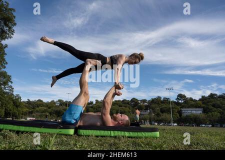 Austin Texas USA, October 17 2021: Man and woman practicing couples yoga poses in Zilker Park on a fall Sunday afternoon. ©Bob Daemmrich Stock Photo