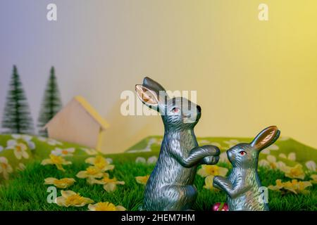 Easter bunny on meadowland with flowers decoration still life Stock Photo