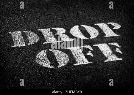 Painted drop off sign on road or parking lot for busses and transportation Stock Photo