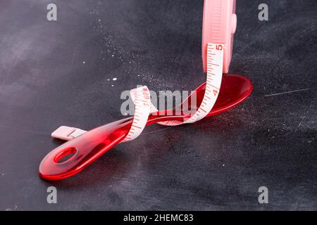 Measuring tape with red plastic spoon Stock Photo
