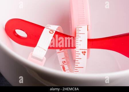 Bowl Measuring tape with red plastic spoon Stock Photo