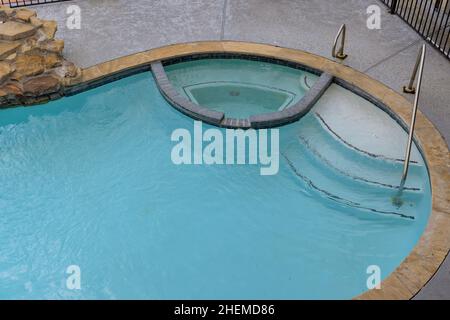 Backyard swimming pool opening with water before cleaning Stock Photo