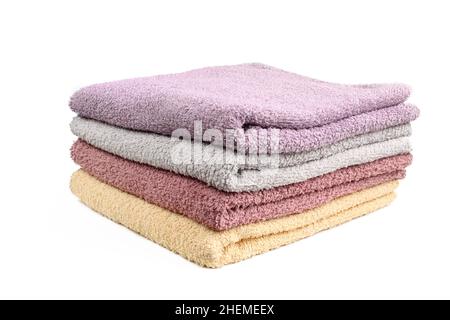 Stack of different color towels isolated on white background Stock Photo