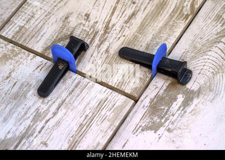 Apparatus for laying stoneware tiles. Leveling system for installing ceramic tiles.. Stock Photo