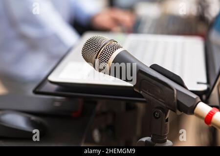 Studio microphone near computer and DJ mixing console to create music and songs in the studio. Microphone and studio equipment for DJ performance at a Stock Photo