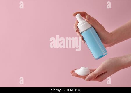 Woman applying cleansing foam to hand close up Stock Photo